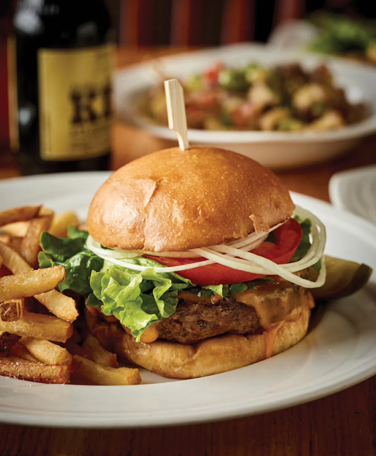 a sandwich with lettuce and fries on a plate